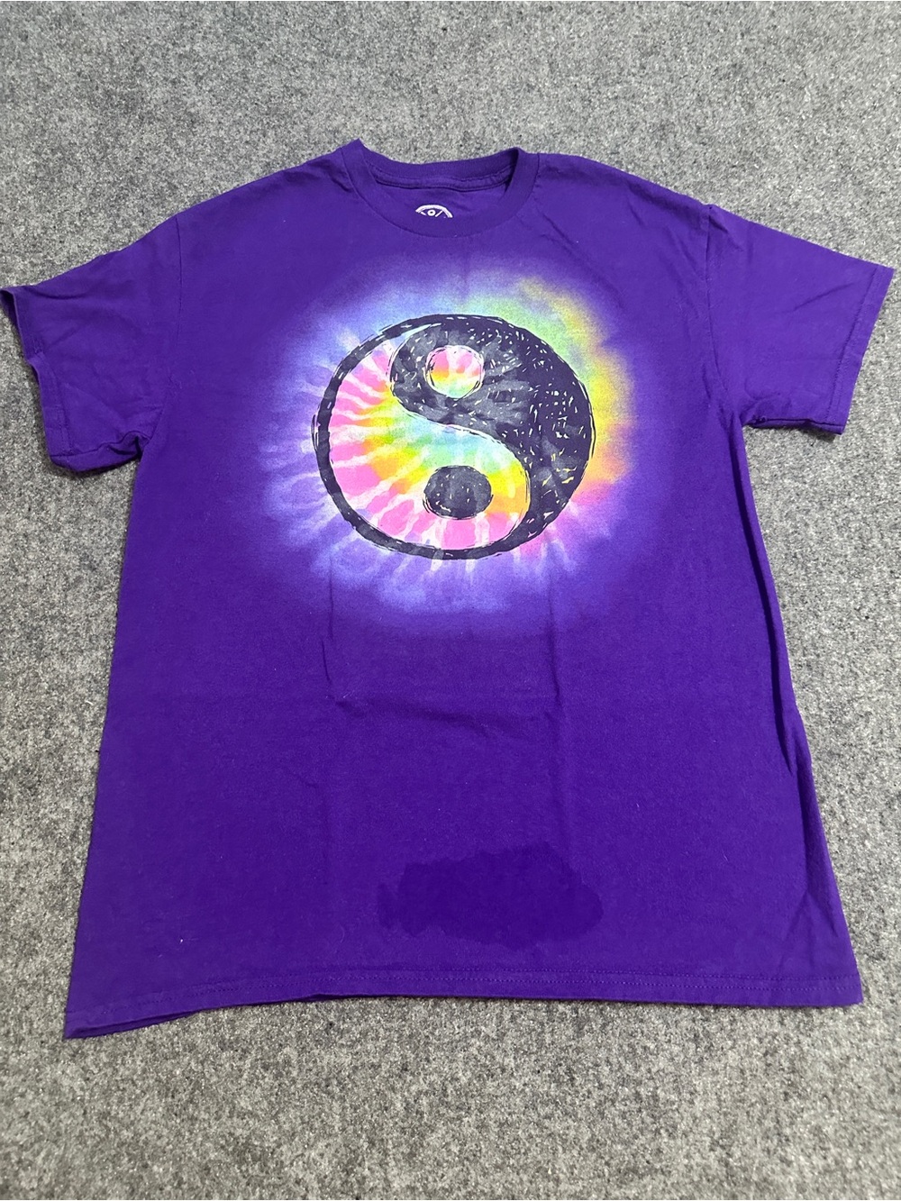 Purple short-sleeve crewneck t-shirt featuring a rainbow tie-dye circle